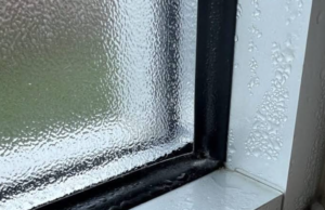 Condensation collecting on a window and frame